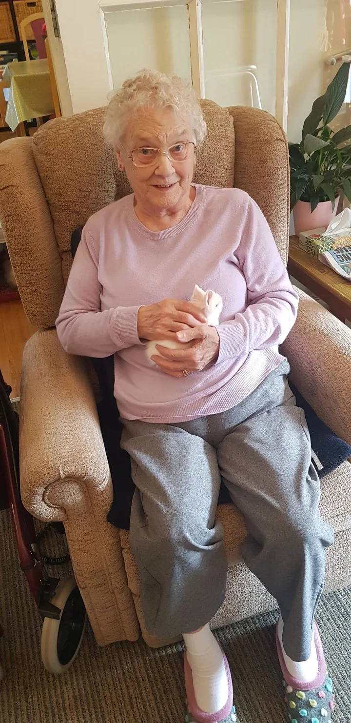 Woman holds what appears to be a tiny kitten