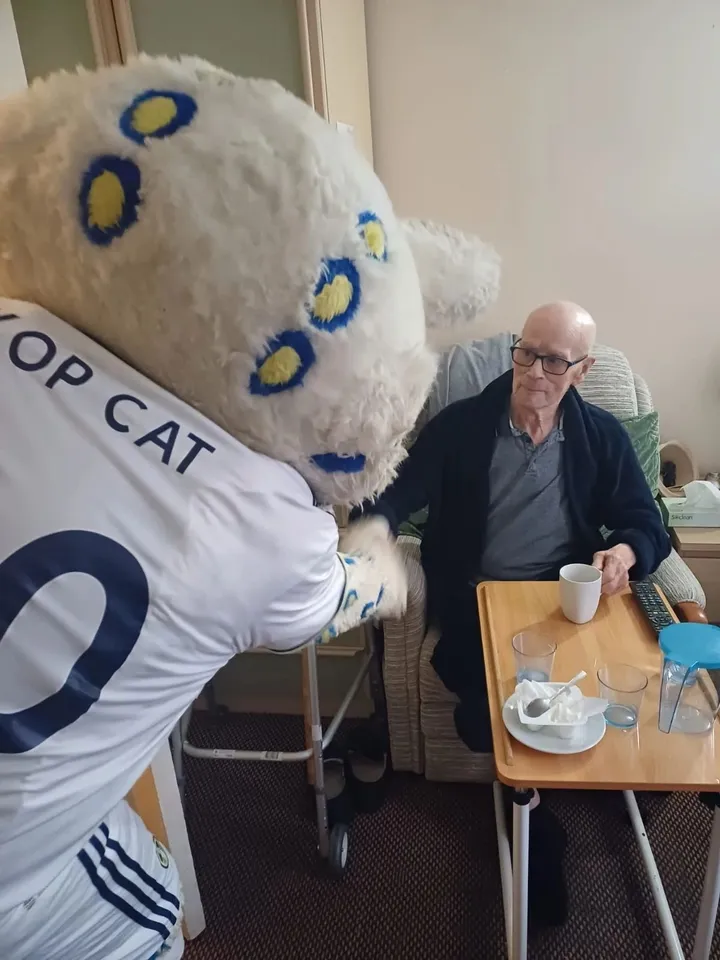 The mascot says hello to a fellow Leeds fan