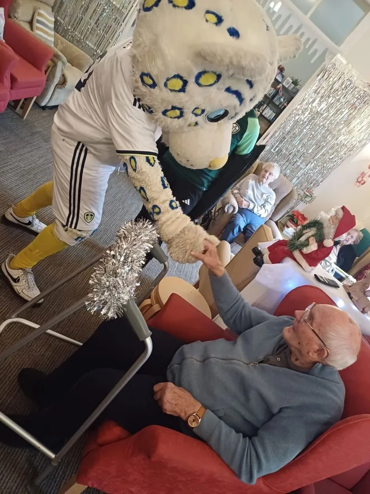 The  mascot greets a happy man